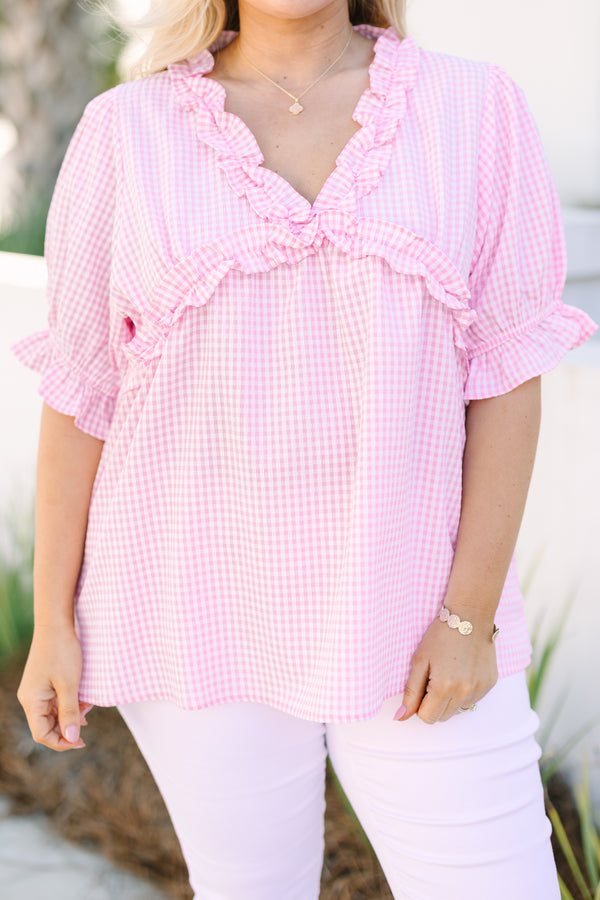 Chic Soul plus size clothing, pink gingham top with short bubble sleeves that have a ruffle detail at the end of each sleeve as well as ruffle detailing along the bottom of the chest and v-neckline 