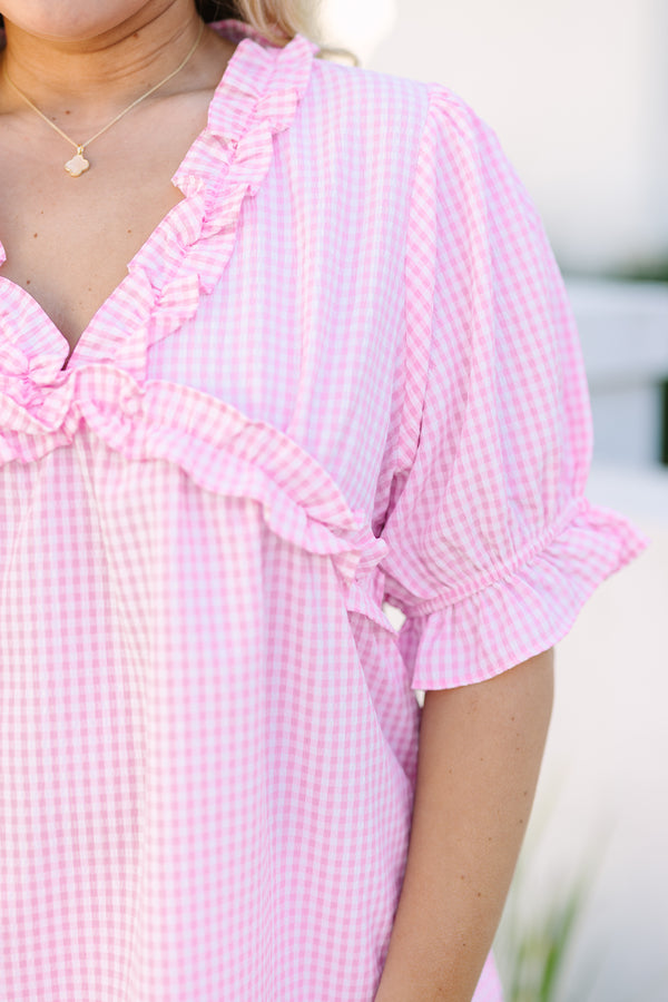 Chic Soul plus size clothing, pink gingham top with short bubble sleeves that have a ruffle detail at the end of each sleeve as well as ruffle detailing along the bottom of the chest and v-neckline 