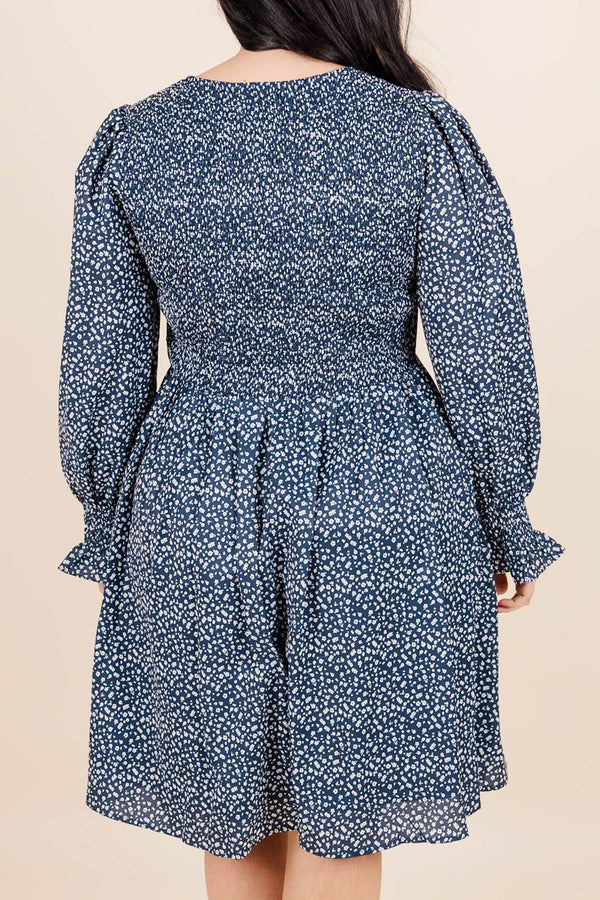 Chic Soul Plus size clothing, navy knee length dress with long sleeves, v-neck and blue and white floral print.