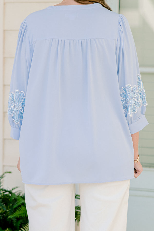 Chic Soul plus size clothing, blue three quarter length sleeve blouse with v cutout along neckline with blue/white embroidered flowers on sleeves with cuff sleeves
