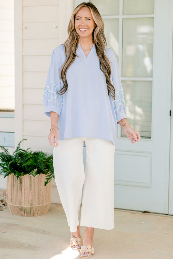 Chic Soul plus size clothing, blue three quarter length sleeve blouse with v cutout along neckline with blue/white embroidered flowers on sleeves with cuff sleeves
