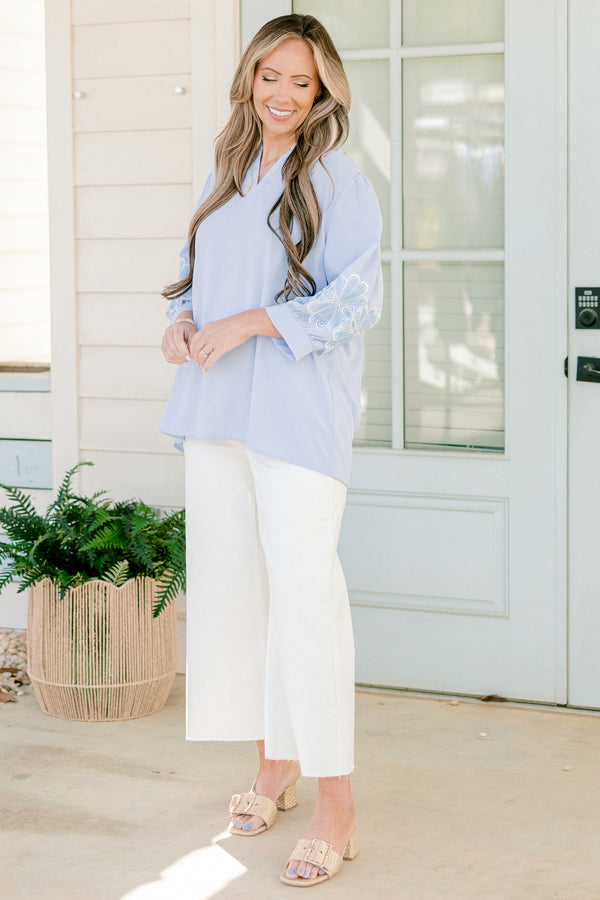 Chic Soul plus size clothing, blue three quarter length sleeve blouse with v cutout along neckline with blue/white embroidered flowers on sleeves with cuff sleeves
