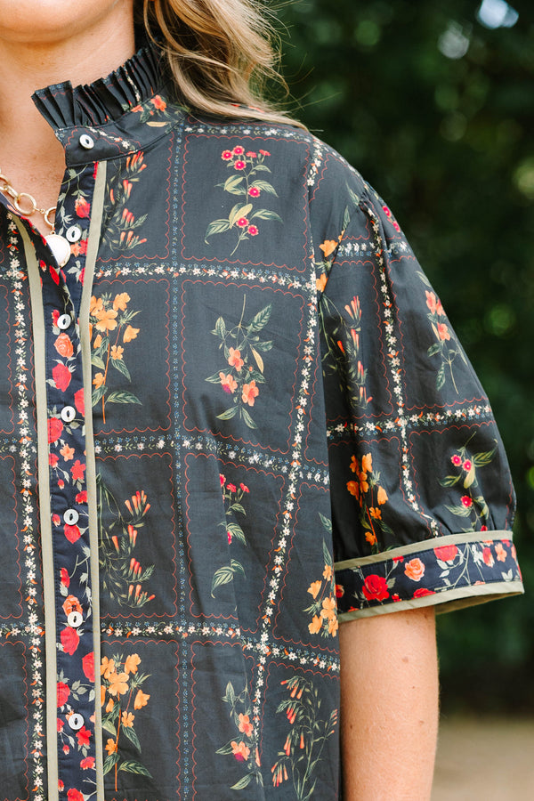 Plus size black cotton button-up top with multi-floral print, puff sleeves, and ruffled collar.
