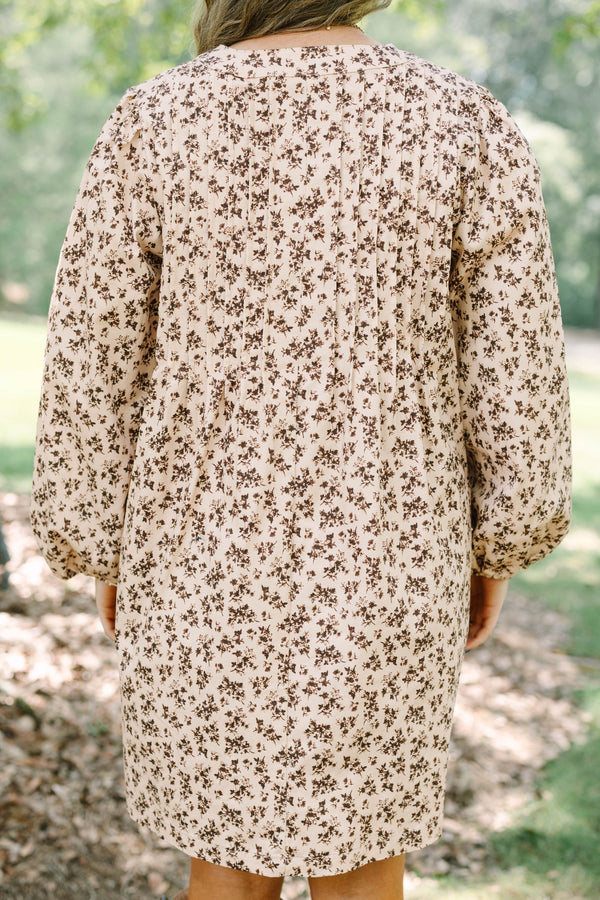 Plus size brown floral mini dress with a flowy fit, V-neck tie, and long puff sleeves.