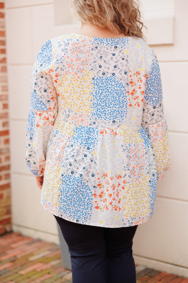 Chic Soul plus size clothing, ivory babydoll top with multicolor color block floral pattern and tassel strings