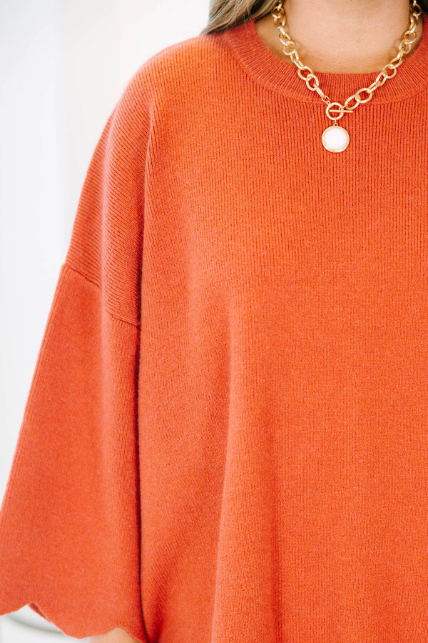 Plus Size rust-colored oversized knit sweater with a crew neckline and scalloped hem.