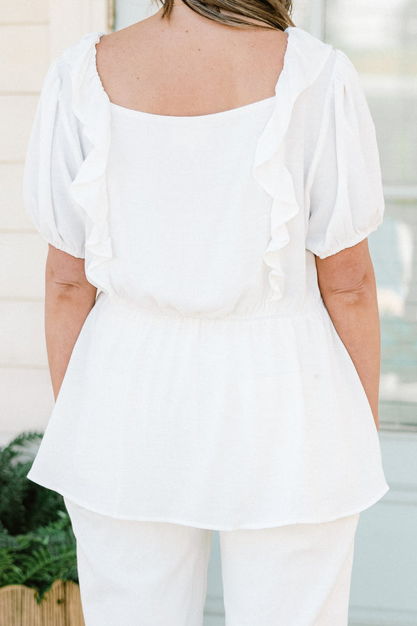 Plus Size white babydoll top with ruffled square neckline and colorful floral embroidery.