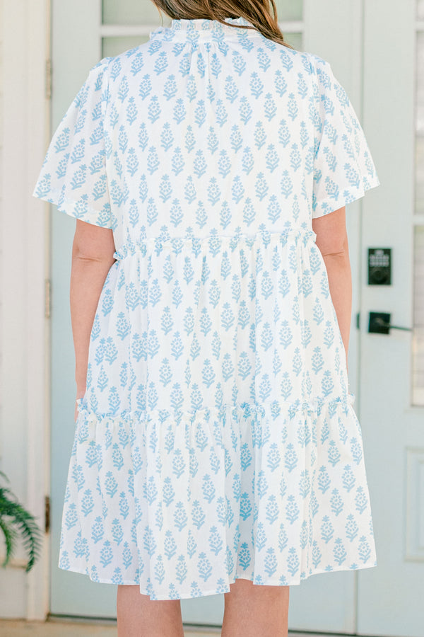 Plus Size white cotton dress with blue floral print, split neckline, neck ties, and tiered skirt.