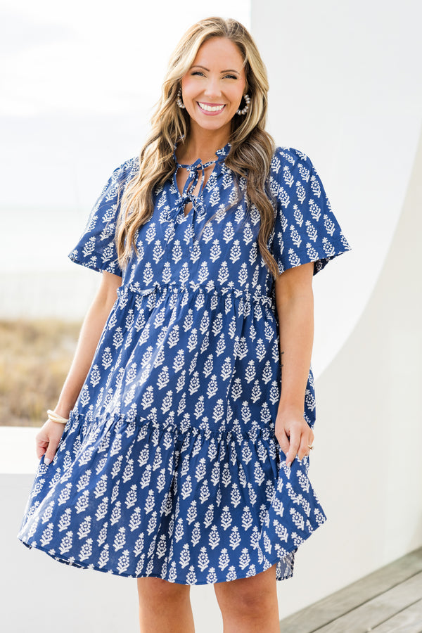 Chic Soul plus size clothing, navy short sleeve mini tiered dress with v cutout along neckline with tie detail with ruffle neckline with white eyelet design with ruffles along tiers