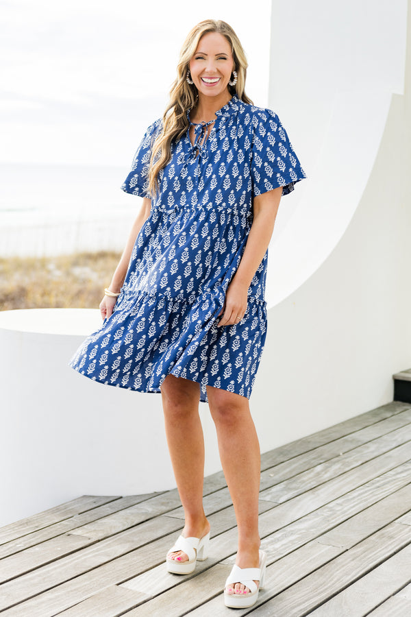 Chic Soul plus size clothing, navy short sleeve mini tiered dress with v cutout along neckline with tie detail with ruffle neckline with white eyelet design with ruffles along tiers