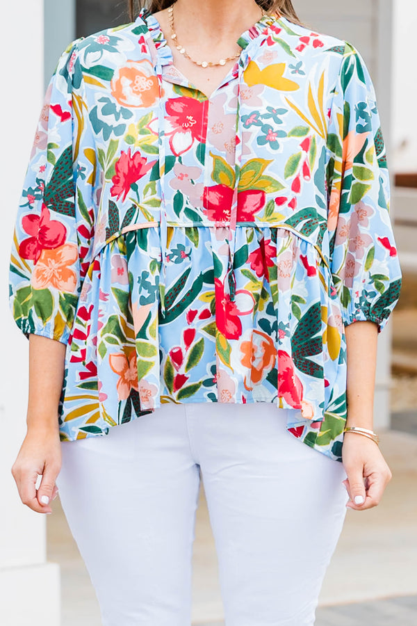 Plus Size blue floral print flowy top with three-quarter sleeves and a tie neckline.