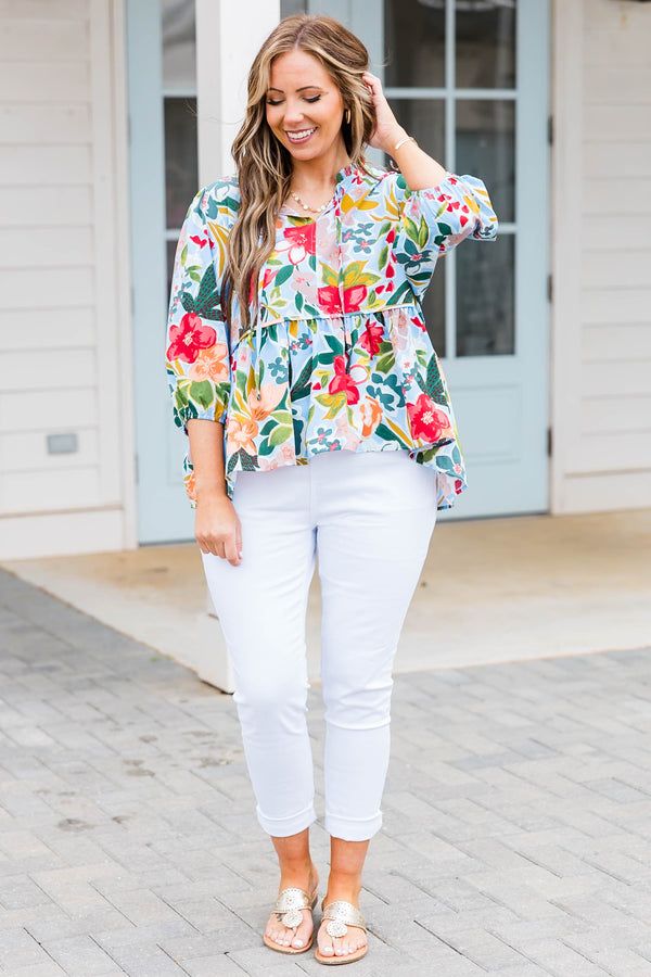 Plus Size blue floral print flowy top with three-quarter sleeves and a tie neckline.