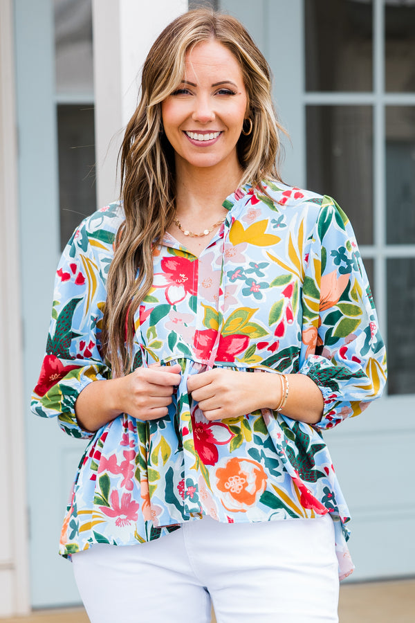Plus Size blue floral print flowy top with three-quarter sleeves and a tie neckline.