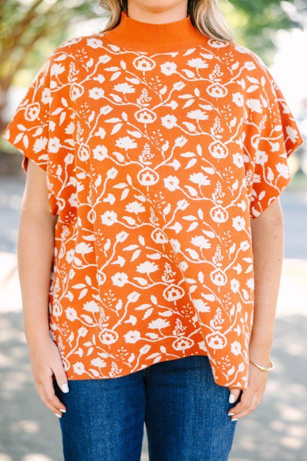 Plus Size rust orange short sleeve mock neck sweater with a white floral knit pattern.