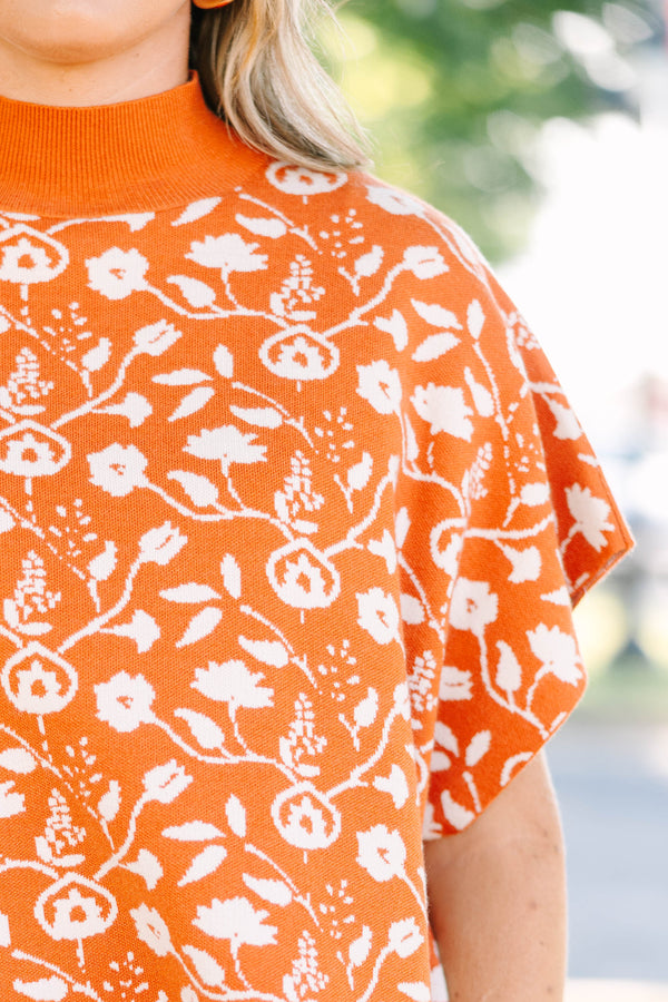 Plus Size rust orange short sleeve mock neck sweater with a white floral knit pattern.