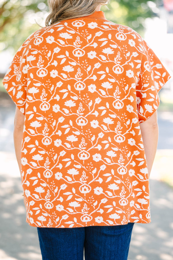 Plus Size rust orange short sleeve mock neck sweater with a white floral knit pattern.