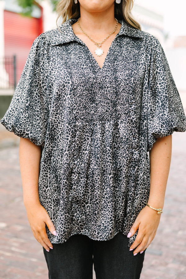 Plus Size leopard print top with smocked bust, collar, and short puff sleeves.