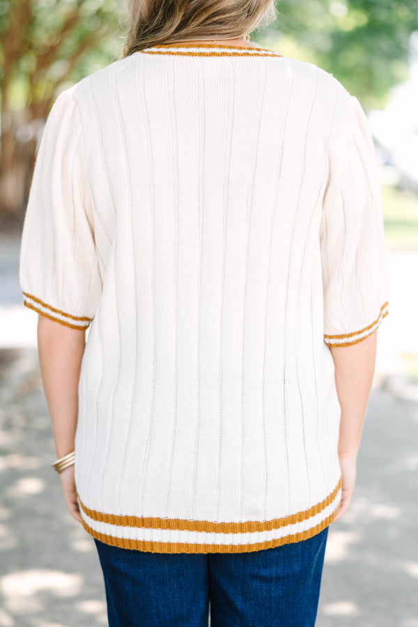 Plus size woman in oatmeal ribbed knit top with mustard stripes
