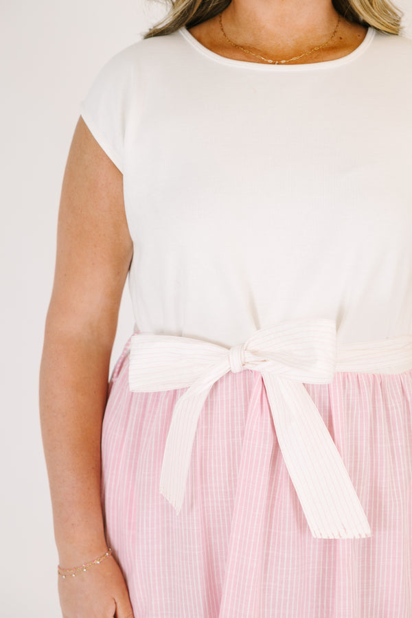 Plus Size maxi dress with a white short-sleeve bodice and a tiered pink striped skirt with a bow.