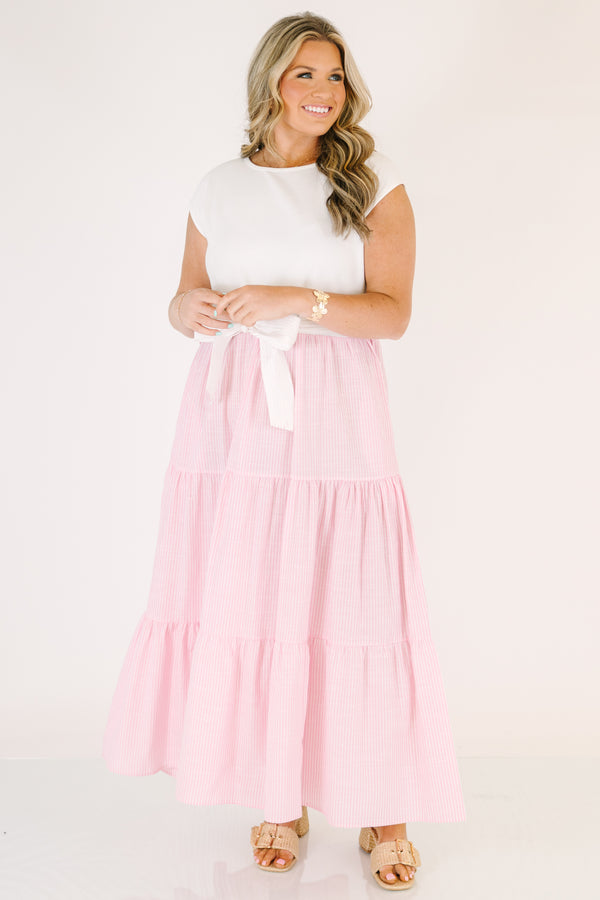 Plus Size maxi dress with a white short-sleeve bodice and a tiered pink striped skirt with a bow.