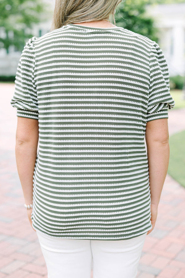 Plus size olive green top with white stitched stripes, puff sleeves, and a relaxed, flowy fit.