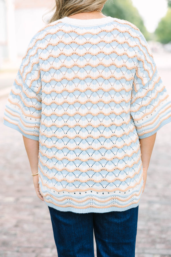 Plus Size blue and tan wavy knit drop shoulder sweater with short sleeves and a crew neckline.