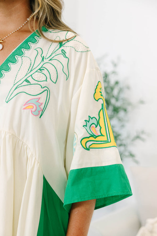 Plus size Dress in green and taupe with boho embroidery and a flowy babydoll fit.