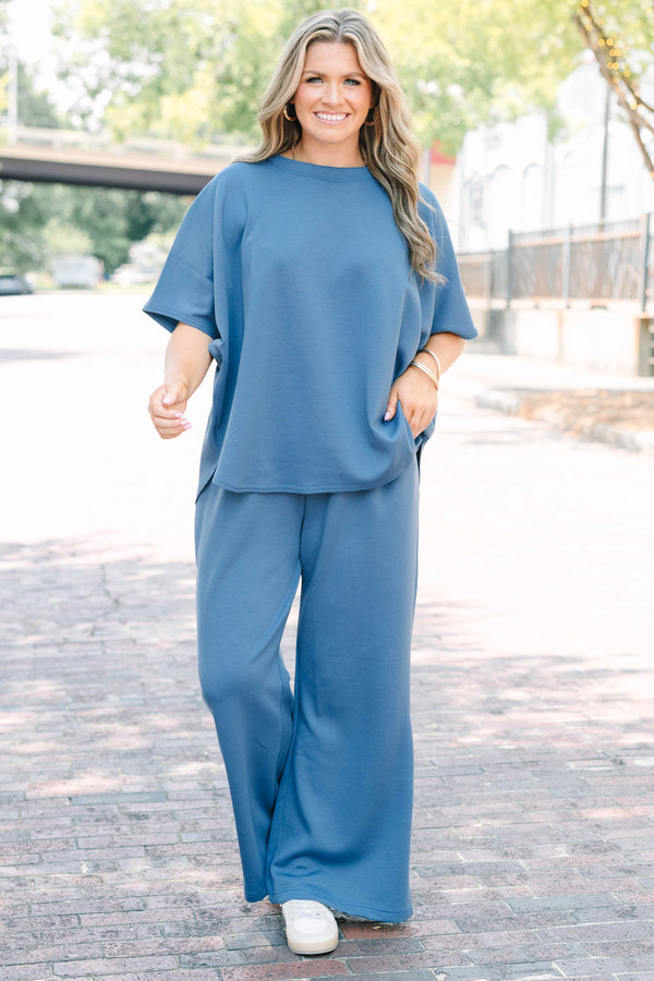 Plus Size dusty blue loungewear set with a short-sleeve curved hem top and matching wide-leg pants.