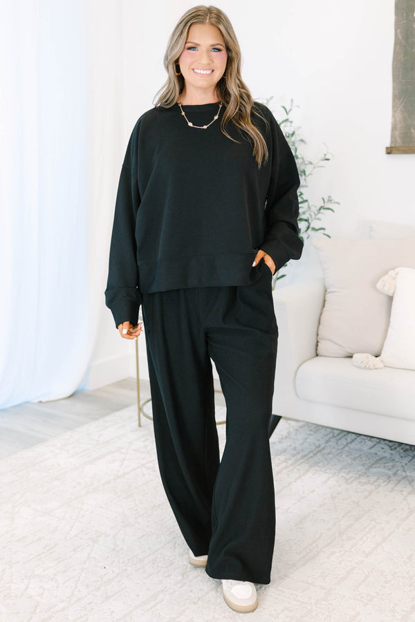 Plus Size black ribbed loungewear set featuring a long sleeve crewneck top and wide-leg pants.