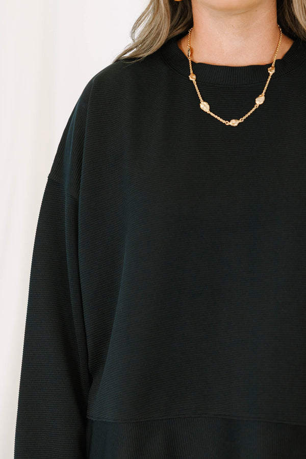 Plus Size black ribbed loungewear set featuring a long sleeve crewneck top and wide-leg pants.