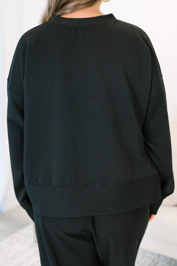 Plus Size black ribbed loungewear set featuring a long sleeve crewneck top and wide-leg pants.