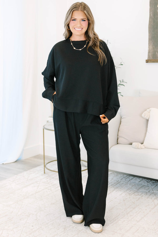 Plus Size black ribbed loungewear set featuring a long sleeve crewneck top and wide-leg pants.
