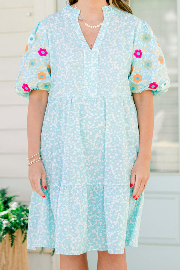 Chic Soul plus size clothing, Turquoise short sleeve dress with a white floral pattern as well as colorful embroidered flowers on the bubble sleeves 