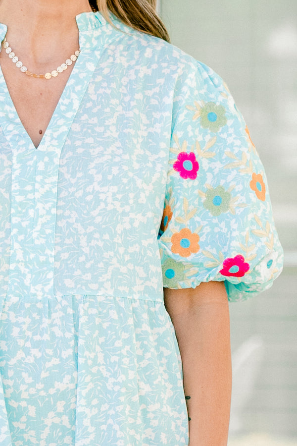 Chic Soul plus size clothing, Turquoise short sleeve dress with a white floral pattern as well as colorful embroidered flowers on the bubble sleeves 