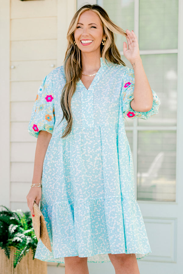 Chic Soul plus size clothing, Turquoise short sleeve dress with a white floral pattern as well as colorful embroidered flowers on the bubble sleeves 