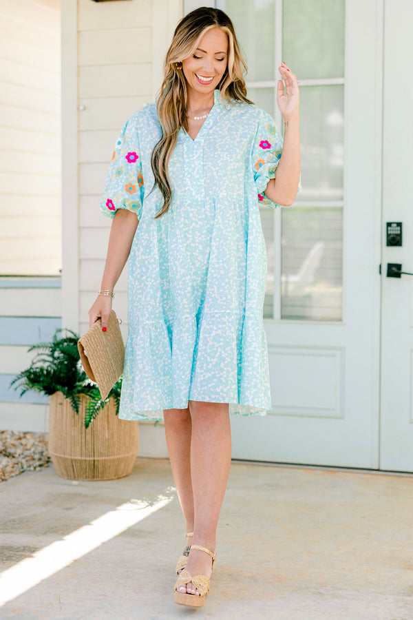 Chic Soul plus size clothing, Turquoise short sleeve dress with a white floral pattern as well as colorful embroidered flowers on the bubble sleeves 