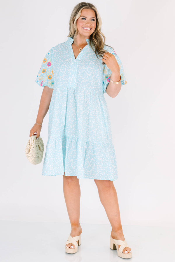 Chic Soul plus size clothing, Turquoise short sleeve dress with a white floral pattern as well as colorful embroidered flowers on the bubble sleeves 