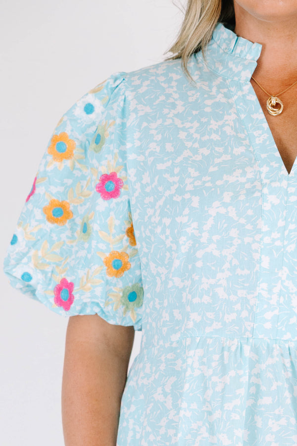 Chic Soul plus size clothing, Turquoise short sleeve dress with a white floral pattern as well as colorful embroidered flowers on the bubble sleeves 