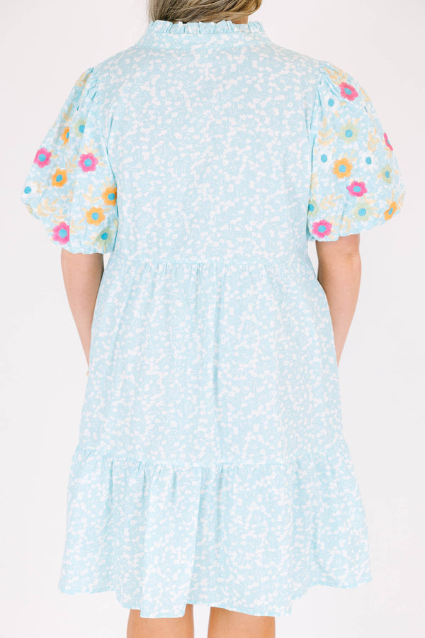 Chic Soul plus size clothing, Turquoise short sleeve dress with a white floral pattern as well as colorful embroidered flowers on the bubble sleeves 