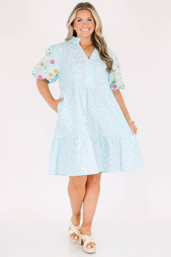 Chic Soul plus size clothing, Turquoise short sleeve dress with a white floral pattern as well as colorful embroidered flowers on the bubble sleeves 