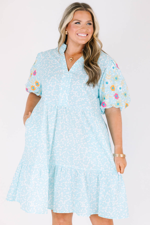 Chic Soul plus size clothing, Turquoise short sleeve dress with a white floral pattern as well as colorful embroidered flowers on the bubble sleeves 