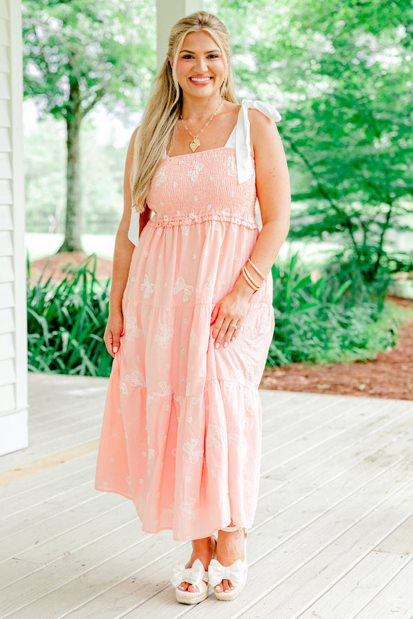 Chic Soul Plus size clothing, pink tiered mid dress with embroidered white bow details and bows that tie on top of the shoulders 
