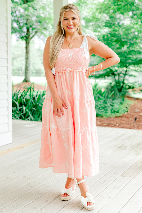 Chic Soul Plus size clothing, pink tiered mid dress with embroidered white bow details and bows that tie on top of the shoulders 
