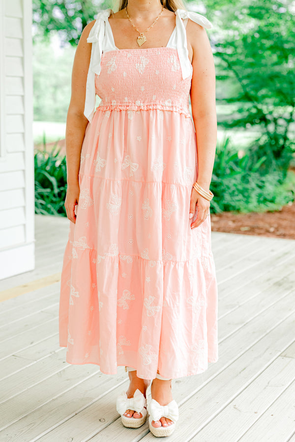 Chic Soul Plus size clothing, pink tiered mid dress with embroidered white bow details and bows that tie on top of the shoulders 
