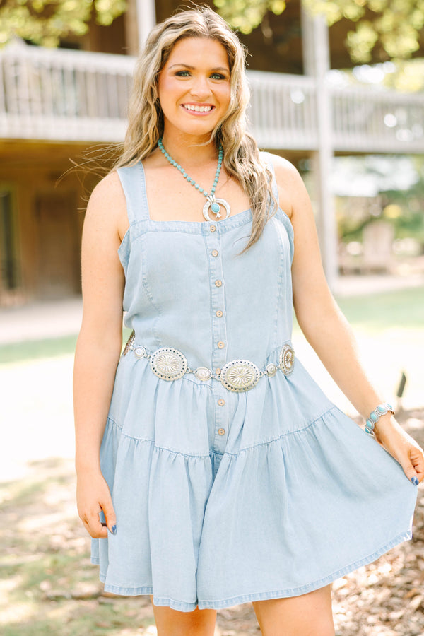 Plus Size light wash denim romper with a button-down front, square neckline, and tiered skirt.
