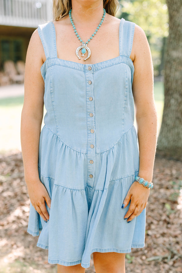 Plus Size light wash denim romper with a button-down front, square neckline, and tiered skirt.