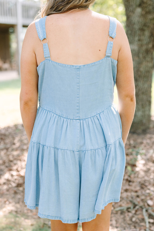 Plus Size light wash denim romper with a button-down front, square neckline, and tiered skirt.