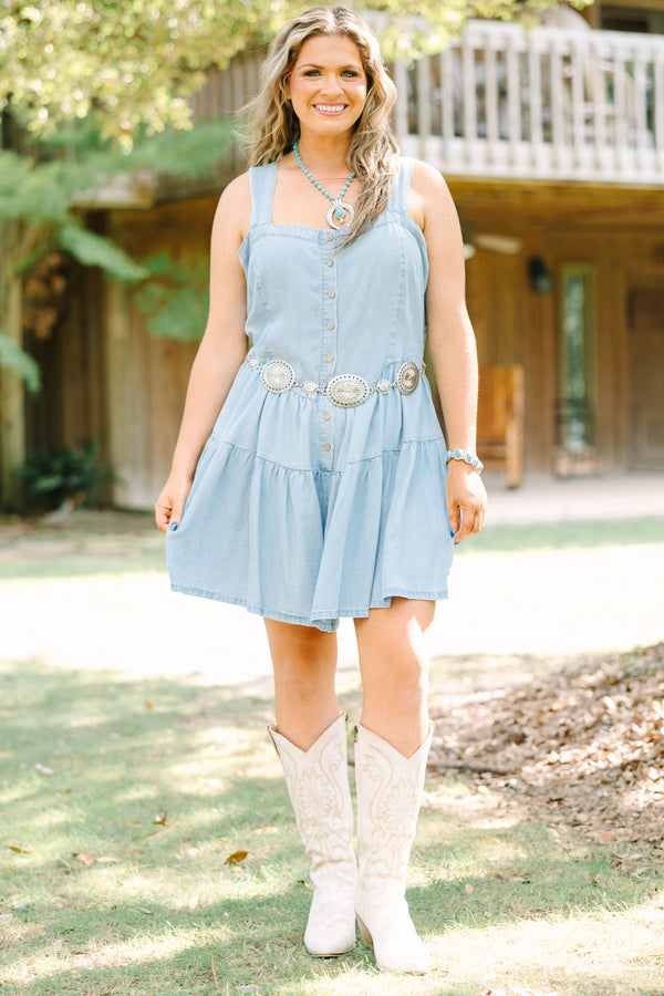 Plus Size light wash denim romper with a button-down front, square neckline, and tiered skirt.
