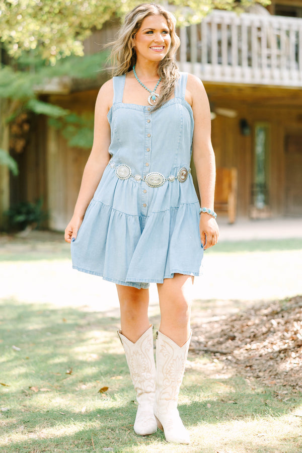 Plus Size light wash denim romper with a button-down front, square neckline, and tiered skirt.