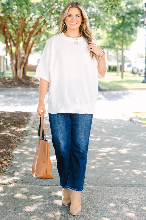 Plus size short-sleeve knit sweater top with a relaxed fit.